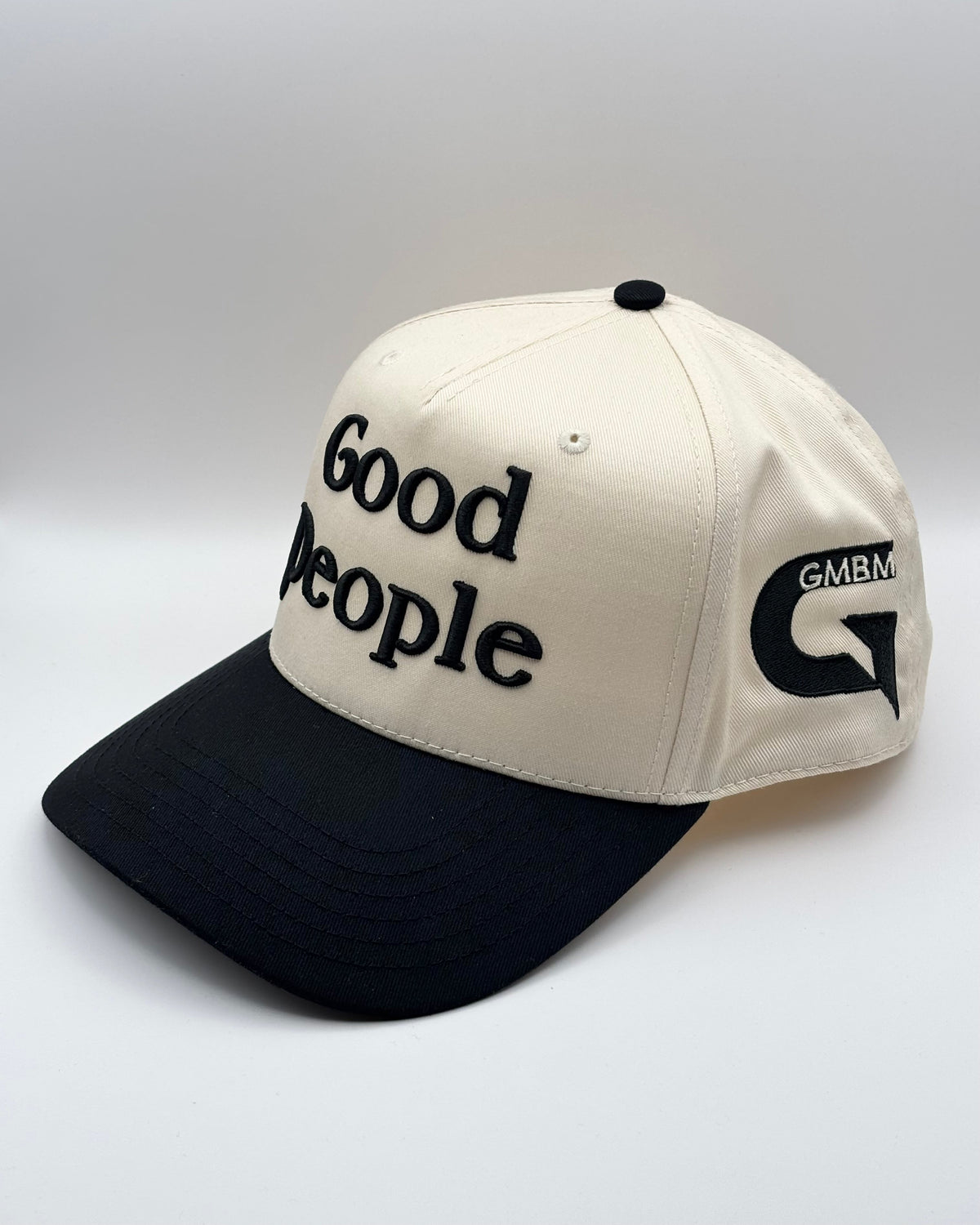 Cap with 'Good People' text and GMBM logo on a white background